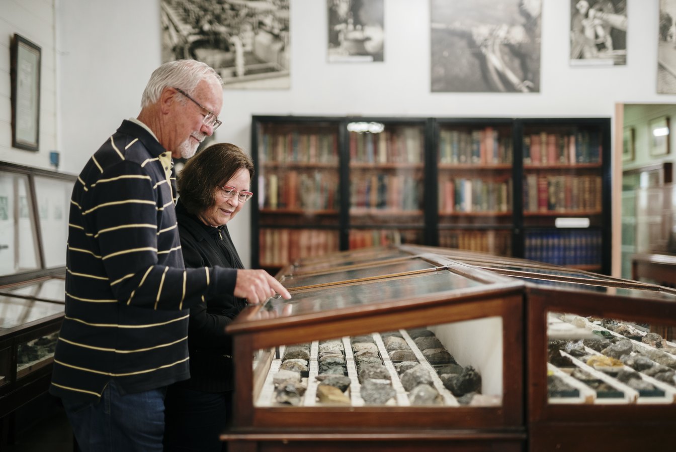 A photo of two people at the West Coast Heritage Centre, looking at a display of minerals, credit Tourism Australia.
