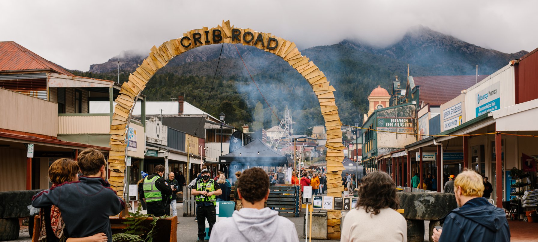 A photo taken on Orr St, Queenstown with Mount Owen standing tall in the background. A tall arch sits in the foreground of the picture, covered in wood planks and reading 'CRIB ROAD' at the top. Credit Jesse Hunniford.