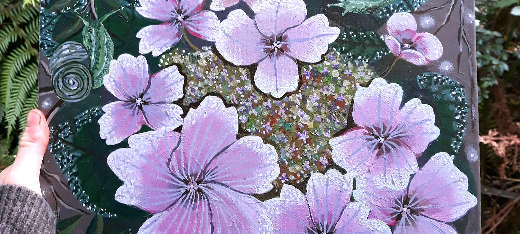 A photo of Tahlia's artwork. The artwork is painted onto a square canvas and features a swirl of purple, pink and white flowers. Surrounding the flowers is a bed of green leaves, branches and curious snails. Credit Tahlia.