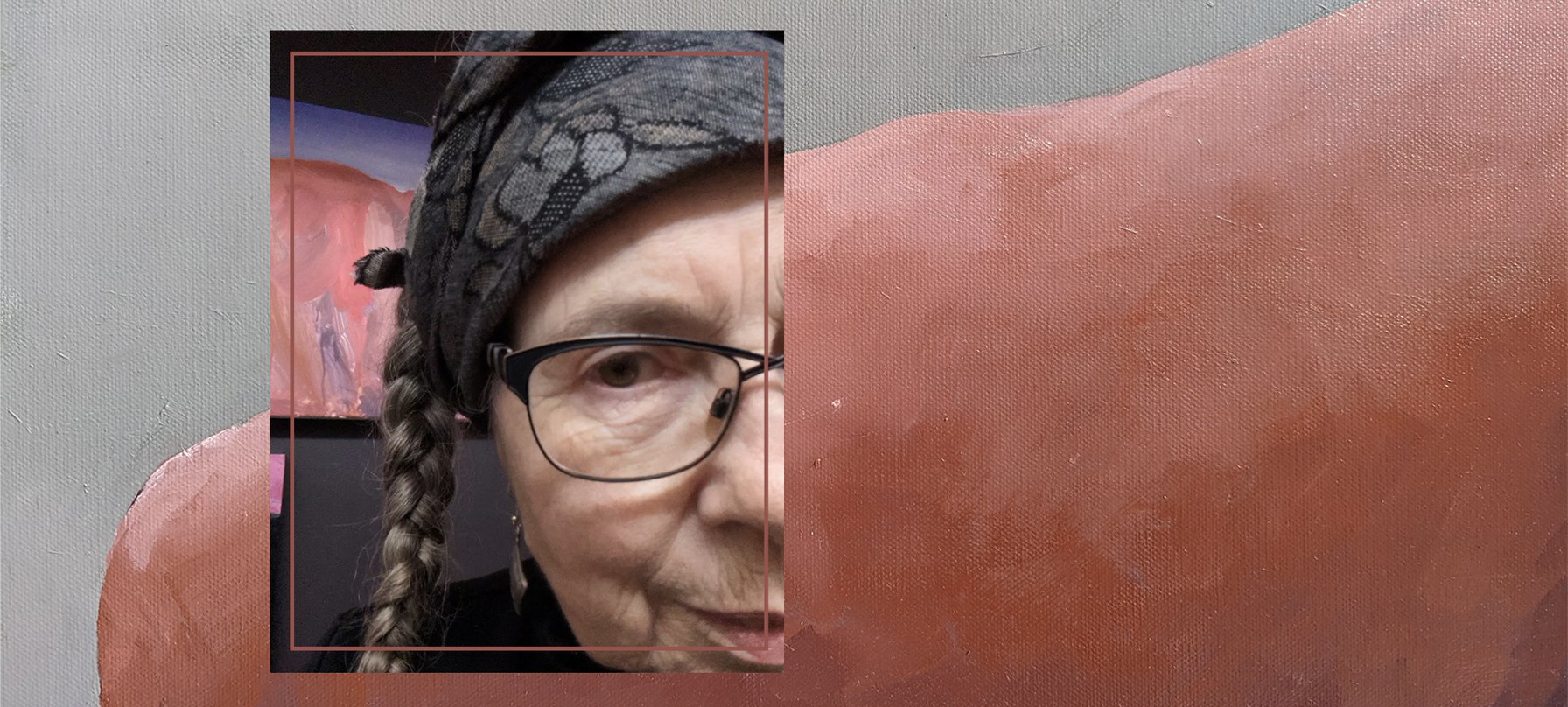 A photo of Julian Greer overlays a photo of her painting, as through she is looking through a window of her work. Half of Julian's face looks out. She smiles. Julian's work uses earthy reds and shadowing to create a rock shape that feels 3D. No credit.