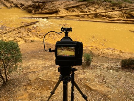A photo of a camera in front of a stream, credit Polly Stanton.