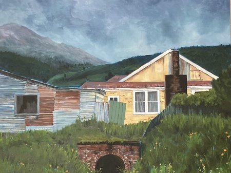A cropped photo of Maxine Brown's painting, featuring a yellow weatherboard house and a tin shed below a murky blue sky and with a mountain in the distance. Credit Maxine Brown.