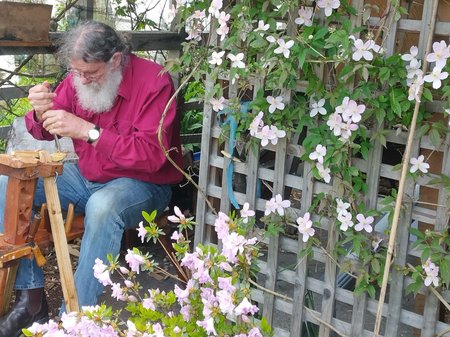 Kim, carving spoons under the clematis arch in our Queenstown, Tasmania garden. copy