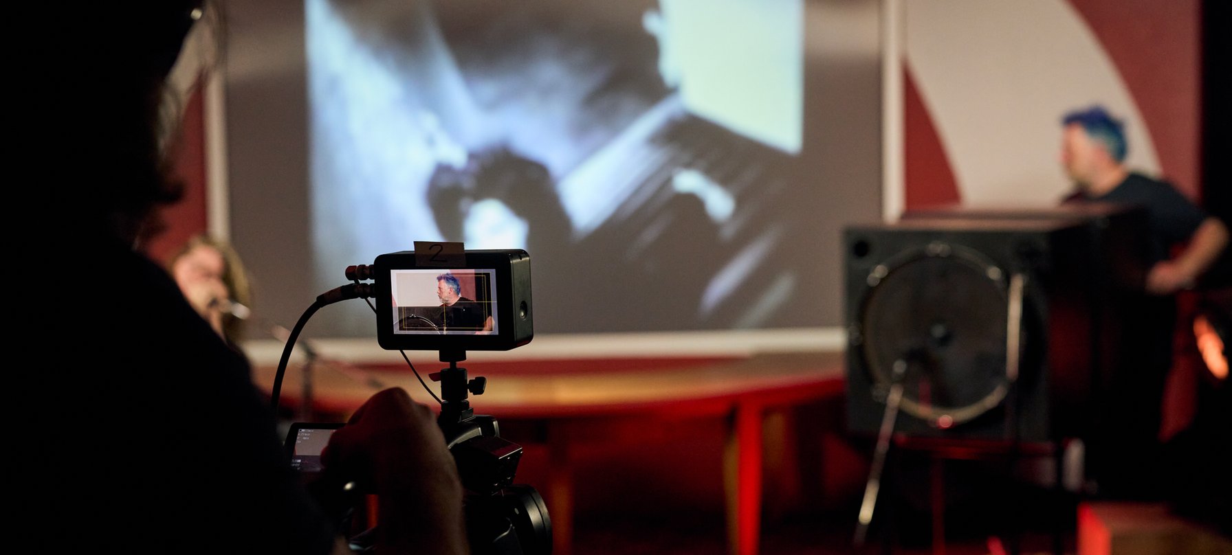 Camera operator filming a live TV show at The Unconformity 2023
