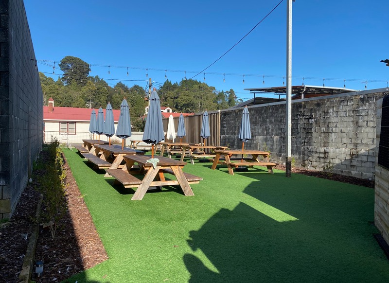 A photo of the Moonscape Wine Bar and Cafe beer garden taken from the entrance gained from the pathway beside the main building on Orr Street.