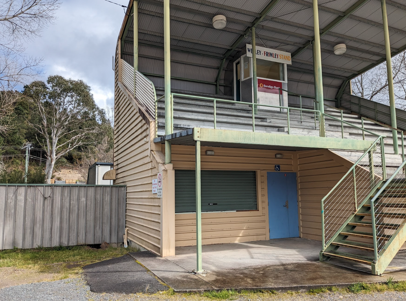 A photo of the Queenstown Football Ground grandstand with the entry to the accessible bathroom below.