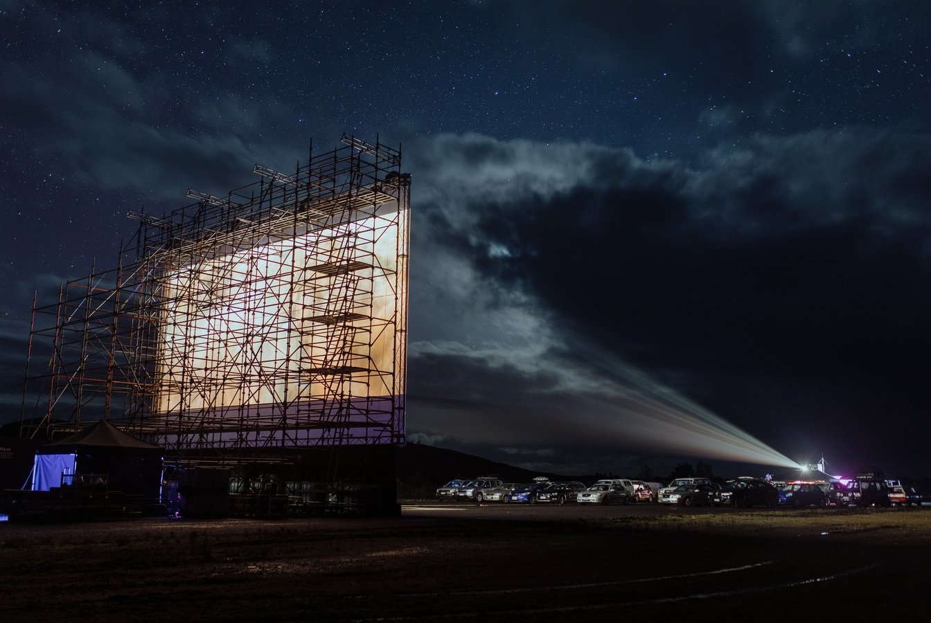 A photo of the film screen an cars at The Unconformity UNTV Drive-In 2022, credit Jesse Hunniford.