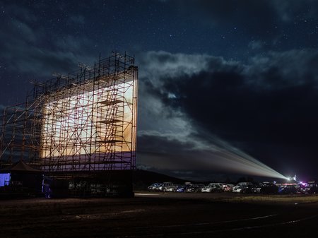 A photo of the film screen an cars at The Unconformity UNTV Drive-In 2022, credit Jesse Hunniford.