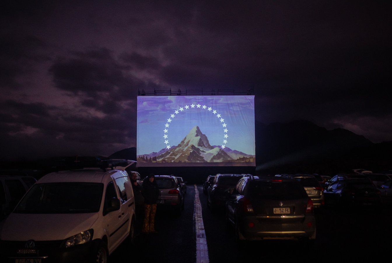 A photo of the film screen an cars at The Unconformity UNTV Drive-In 2022, credit Jesse Hunniford.