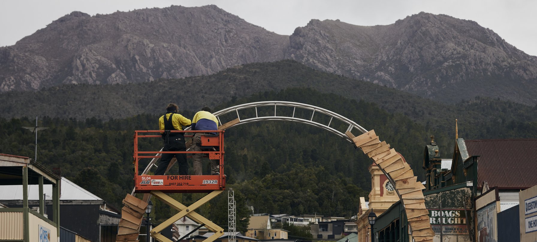 Two workers in high visibility clothing constructing the archway entrance to Crib Road.