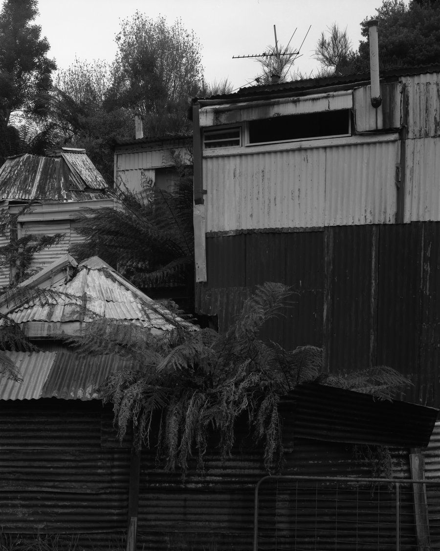 The house of deceased artist Leo Kelly sits precariously in the shadows of the hills. Leo created the piecemeal structure himself and it includes separate rooms for prayer, astrology and photo processing.