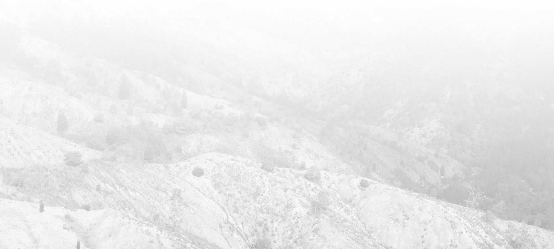 MOONLAND image. A photo of a rocky landscape washed with a white light so bright that you lose track of the landscape in the distance. The bright light is coming from above. Credit Jack Robert-Tissot.